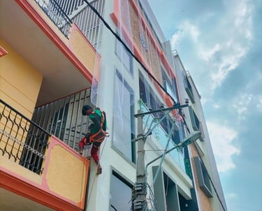 Close-up of a sturdy pigeon net tightly fitted on a balcony railing in a sunny Anna Nagar apartment.