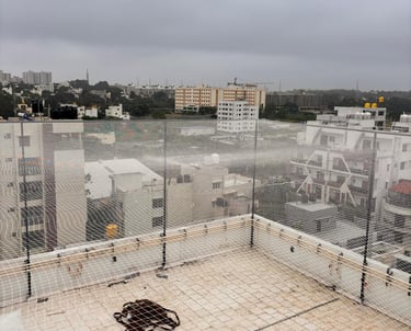 A freshly installed cricket net enclosure at a local Vijayawada sports ground under a clear blue sky