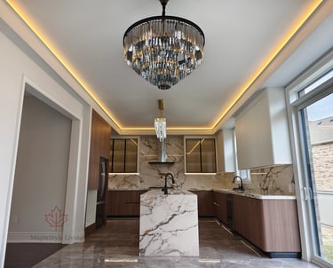 Luxury modern kitchen completion featuring a massive Calacatta marble waterfall island, custom wood 