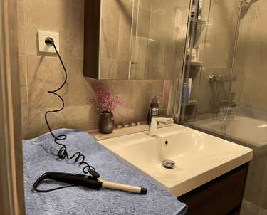 a hair dryer sitting on a towel in a bathroom