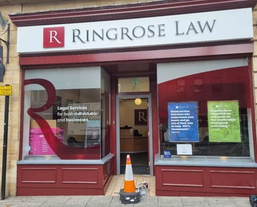Front of Ringrose Law firm, with large branded windows and freshly red-painted detailing.