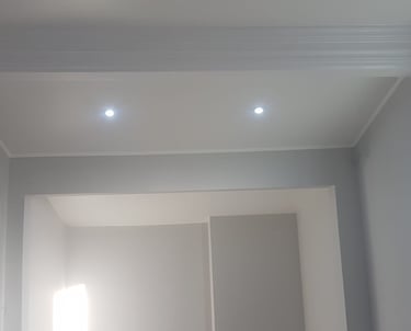 A well-lit, pale-white room with a concave space in the wall.