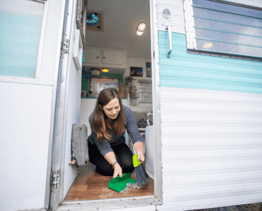 a woman cleaning a camper