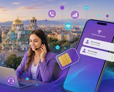 Customer support agent with headset using a laptop near a large smartphone and Bulgarian cathedral.