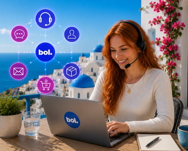 A smiling customer service agent for bol.com working remotely on a laptop in Santorini, Greece.