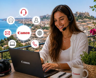 A smiling remote worker using a Canon laptop and headset for customer support with a scenic ocean view.