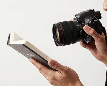 A professional photographer setting up a shot of a book against a clean white background for a marketing campaign.