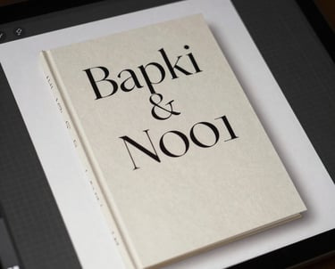 A close-up of a designer's screen showing an elegant book cover design in progress with serif typography.