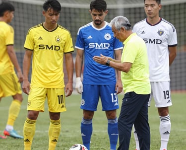 A professional scout from West Ham United analyzing a young player’s technique on the football field.