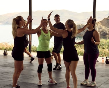 a fitness group giving high-fives at the end of a workout