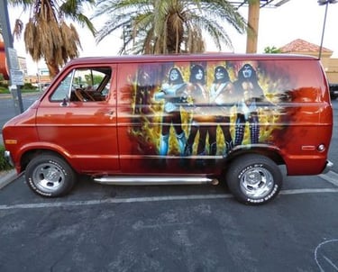 a van with a large painting on it of the band Kiss