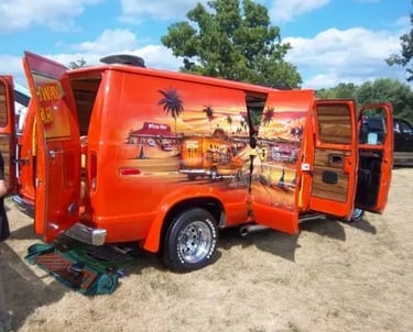 a man standing next to a van with a surfboard