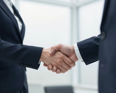 Close up of two professionals in suits shaking hands to seal a business deal or partnership.