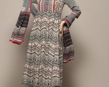 Woman wearing a grey and red printed Anarkali kurta set with dupatta and palazzo pants.