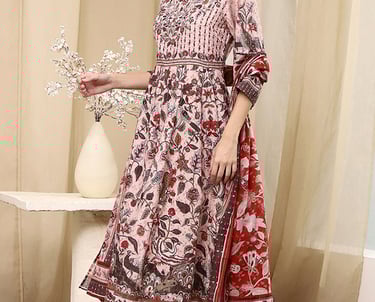 Woman wearing a floral print Anarkali kurta set with matching leggings and dupatta.