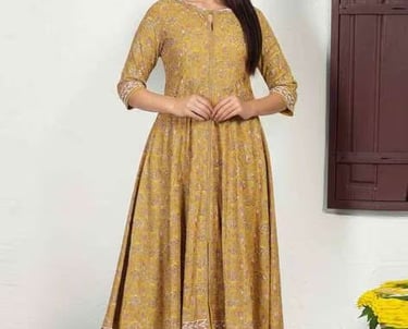 Woman wearing a yellow floral printed Anarkali kurti with beige trousers.