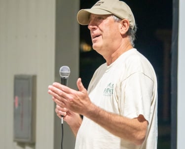Man holding a microphone talking
