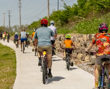Photo from the back of the line of bikers of all ages