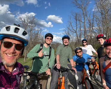 Group image of people in helmets on bikes posing