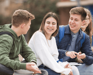 a group of young people sitting on a bench