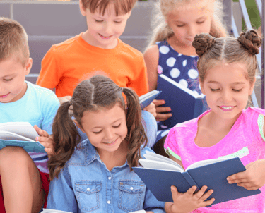 a group of children reading books on stairs