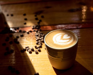 a cup of coffee with a coffee cup in the background