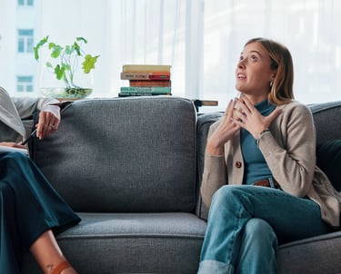 Women sitting on a therapy couch after having found the best calgary therapist