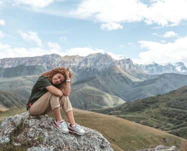 Woman sitting in mountain landscape
