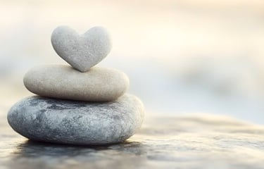 a stack of stones with a heart shaped stone