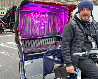 a man riding a bicycle with a purple cover