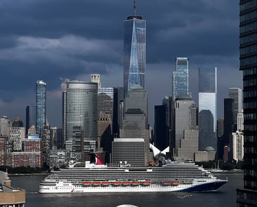 a cruise ship in the water near a city