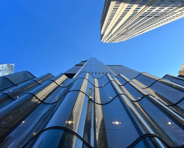 a tall building with a very tall building in the background
