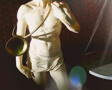 a statue of a man with a lamp on a table