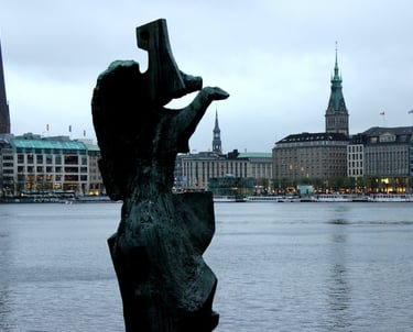 a statue of a figure overlooking a body of water
