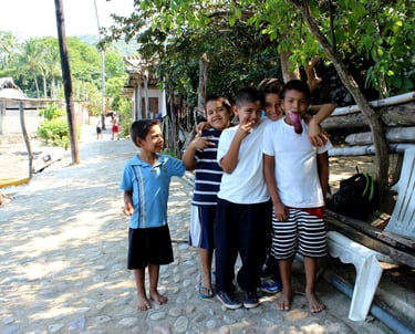 a group of children wait for the bus in Puerto Vallarta