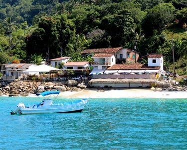 a boat in the water near a beach in Puerto Vallarta