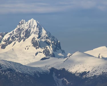 a mountain range with snow covered mountains in the background