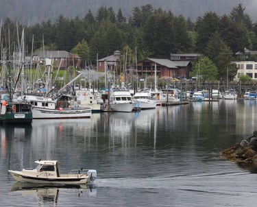 a boat in the water near a dock with many boats