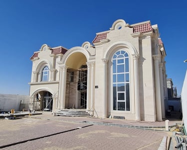 Grand villa with classical façade featuring arched windows, elegant columns, and aluminum framing, c
