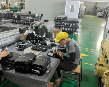 A King Fly team member performing meticulous quality control on a custom bag production line.