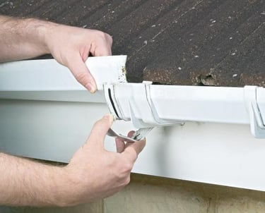 "Minor gutter repairs being performed by PJB Exterior Cleaning in Norwich, Norfolk, showing a techni