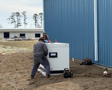 two williams electric, techs installing a commercial standby generac generator next to a commercial building