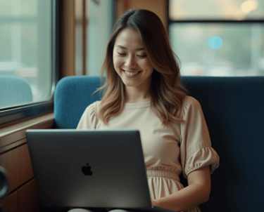 a woman sitting on a couch with a laptop computer
