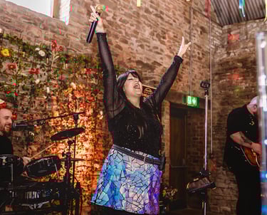 a woman in a skirt and a man in a black shirt and a microphone