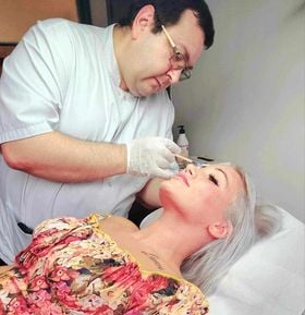 a woman getting her eyebrows done by a professional hairdresser