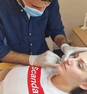 a man in a mask and gloves is getting a checkup