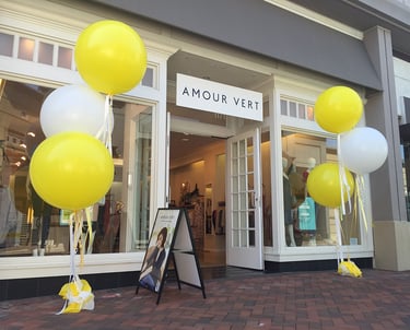 a storefront door with balloons and balloons