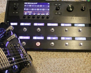 A Line 6 Helix multi-effects guitar processor pedalboard, electric guitar, inquire for lessons.