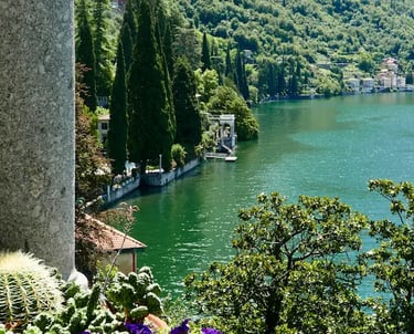 Scenic view of Lake Como with blue water, surrounding mountains, and Italian villas on the shore