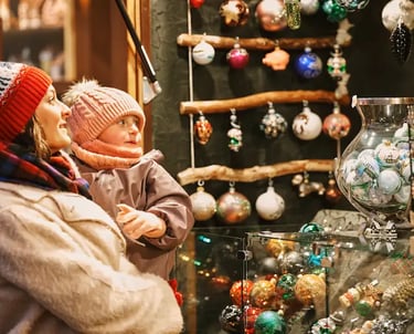 "Mother and child enjoying Christmas ornaments at Bolzano Christmas Market in South Tyrol